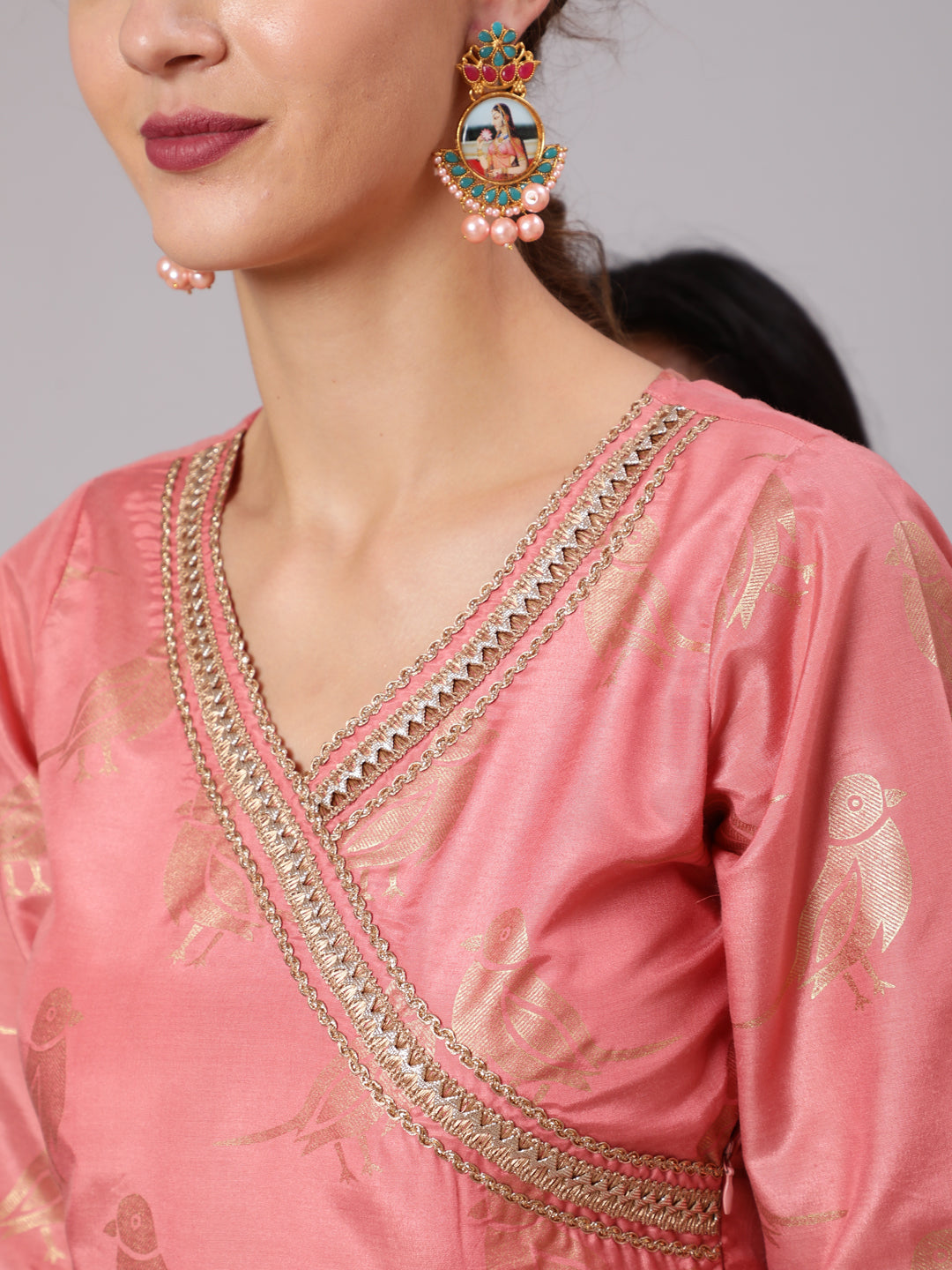 A Peach Color Bird Printed Silk Blend Peplum Top And Skirt With A Gold Print Net Dupatta