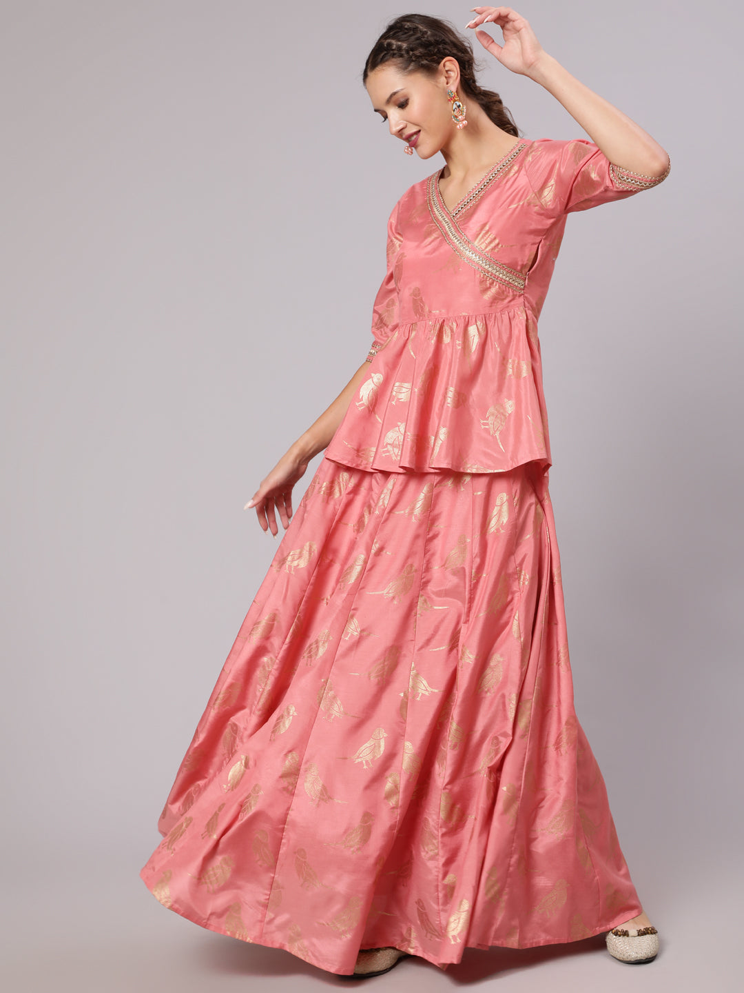 A Peach Color Bird Printed Silk Blend Peplum Top And Skirt With A Gold Print Net Dupatta