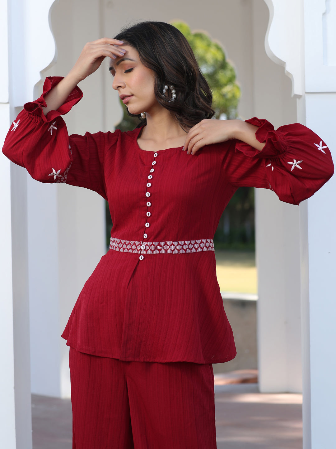 A Red Color Embroidered Lyrca Georgette Textured Co-Ord Set With Peplum Top And Palazzo