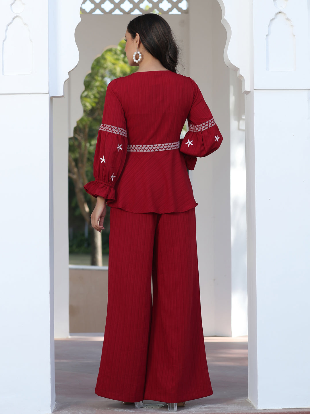 A Red Color Embroidered Lyrca Georgette Textured Co-Ord Set With Peplum Top And Palazzo