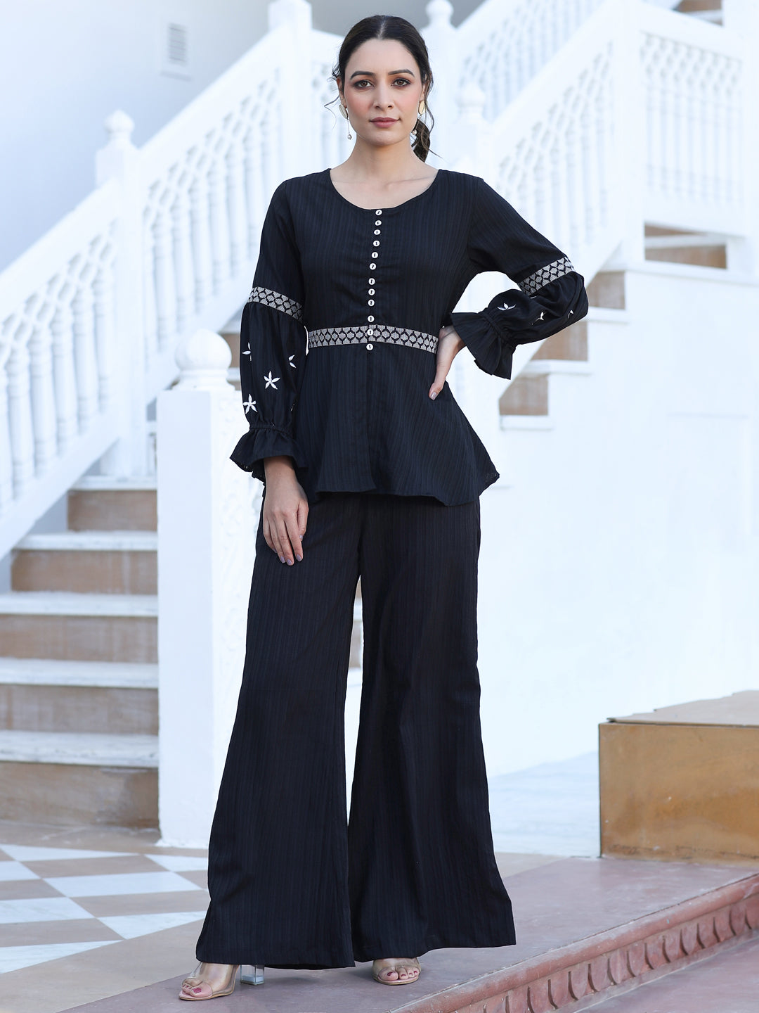 A Black Color Embroidered Lyrca Georgette Textured Co-Ord Set With Peplum Top And Palazzo