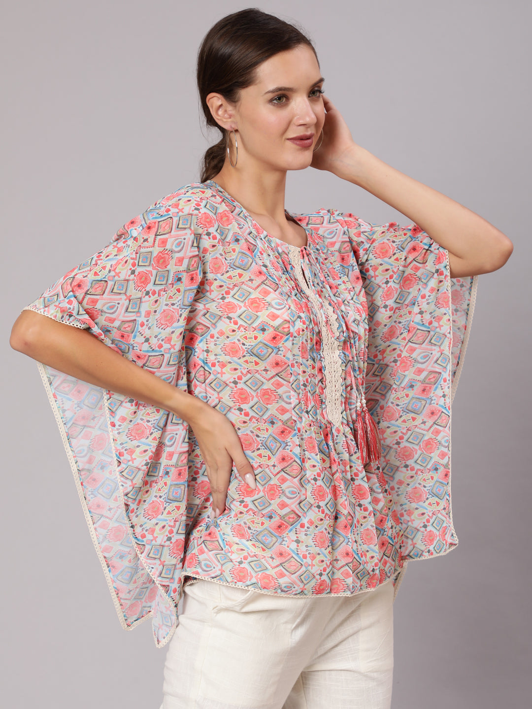 A Peach Geometric Printed Georgette Kaftan Top With Pintucks And Lace Details At The Yoke With Off- White Cotton Pants