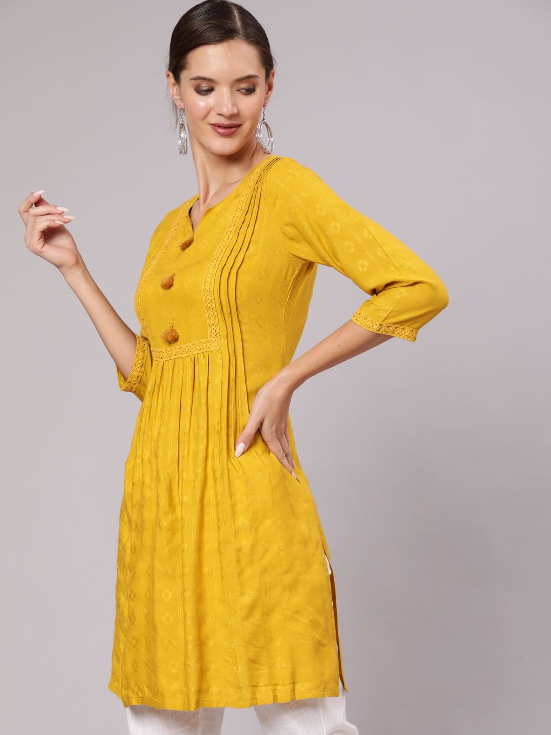 Mustard Self Weave Pleated, Laced-Up And Gathered Short Kurta With Tassels