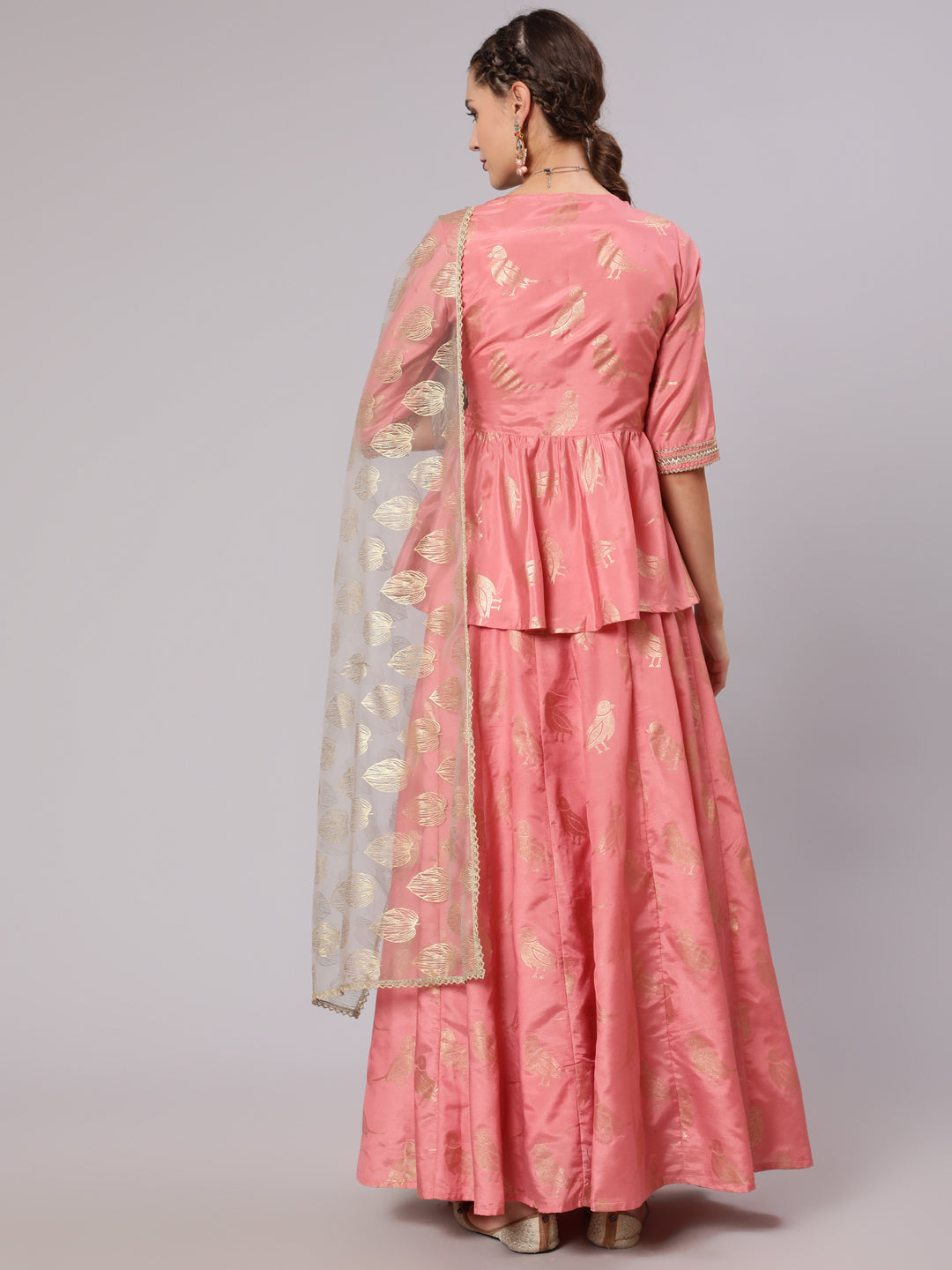 A Peach Color Bird Printed Silk Blend Peplum Top And Skirt With A Gold Print Net Dupatta
